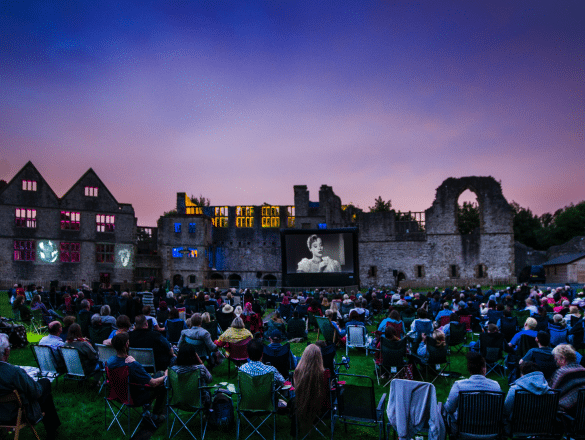 A sea of people watch a film on an inflatable screen, outside Dudley castle. Film funding in the Midlands.