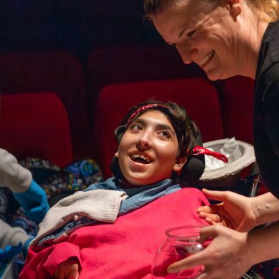 A person in a wheelchair looking up at the Touch Screen facilitator at Midlands Arts Centre