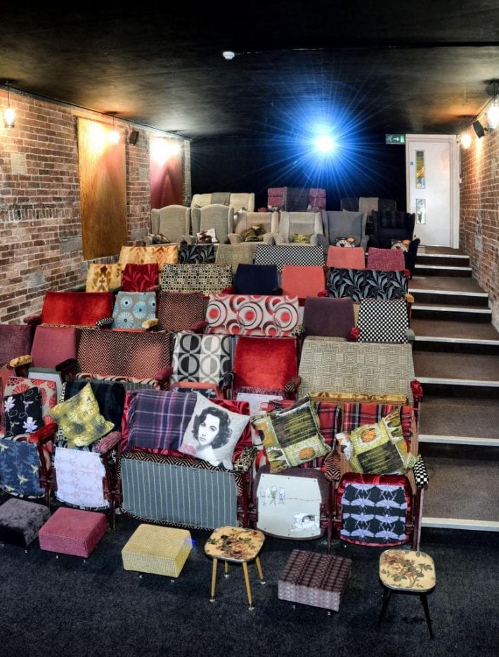 Inside the small boutique Northern Light Cinema, bright comfortable sofas and cushions