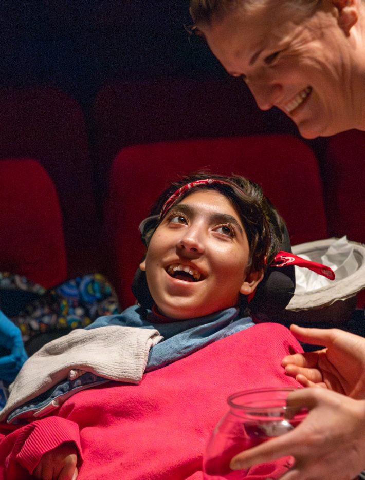 A person in a wheelchair looking up at the Touch Screen facilitator